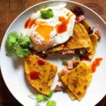 Ham and cheese quesadilla made with corn tortillas and topped with a fried egg.
