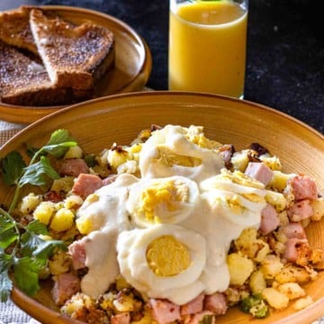 Ham Hash with mustard cream sauce topped with sliced hard boiled eggs.