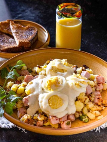 Ham Hash with mustard cream sauce topped with sliced hard boiled eggs.