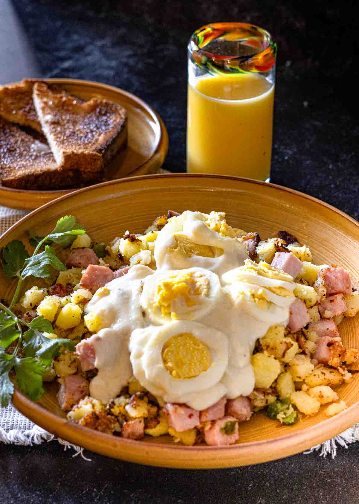 Ham Hash with mustard cream sauce topped with sliced hard boiled eggs.