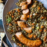 Italian sausage and lentils on a serving platter.