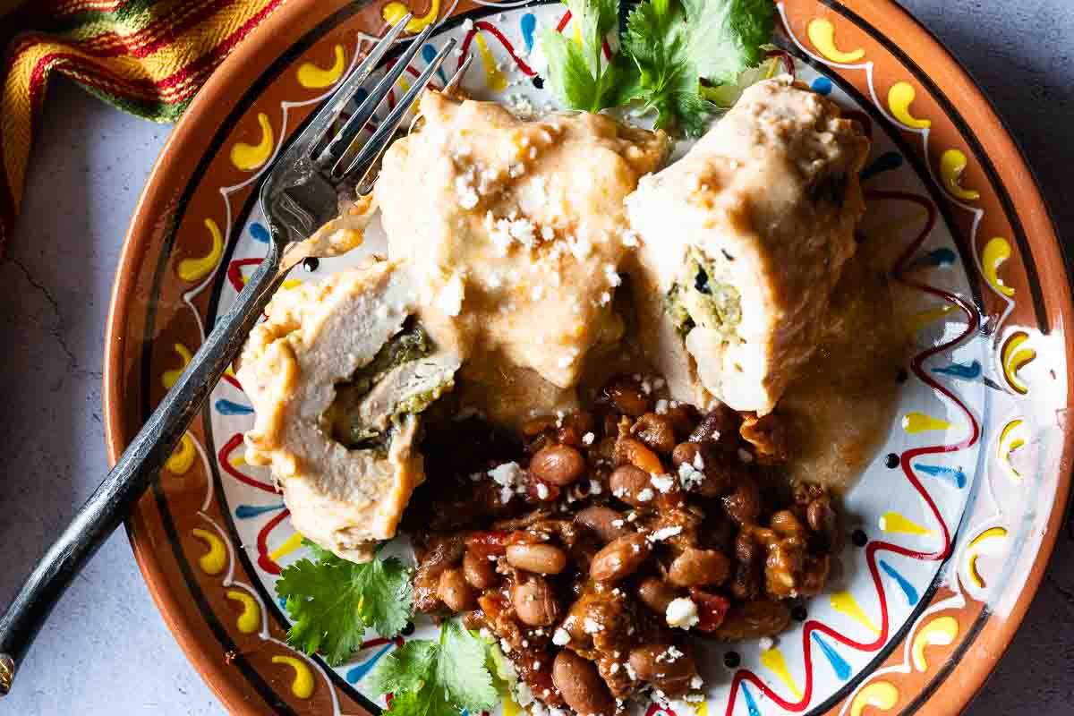 Green chile cheese baked chicken cutlets served with cowboy beans.