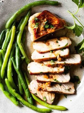 Honey garlic pork chops served with green beans.