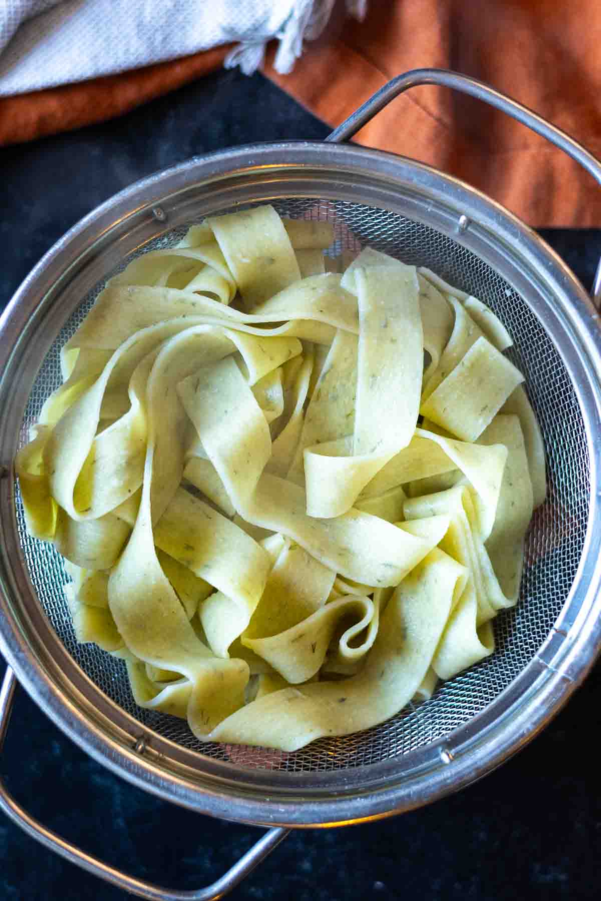 Cooked pappardelle pasta in a colander to make chicken fajita pasta.