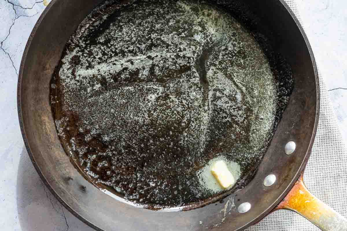 Melting butter and honey in a cast iron skillet.