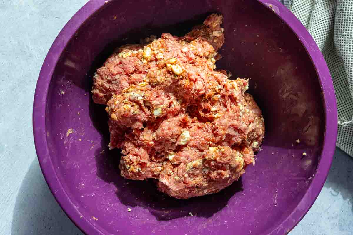 Combined ground beef and blue cheese crumbles to make black and blue burgers.