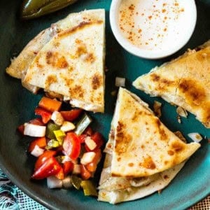 Chili's chicken bacon ranch quesadillas on a blue plate served with pico de gallo.