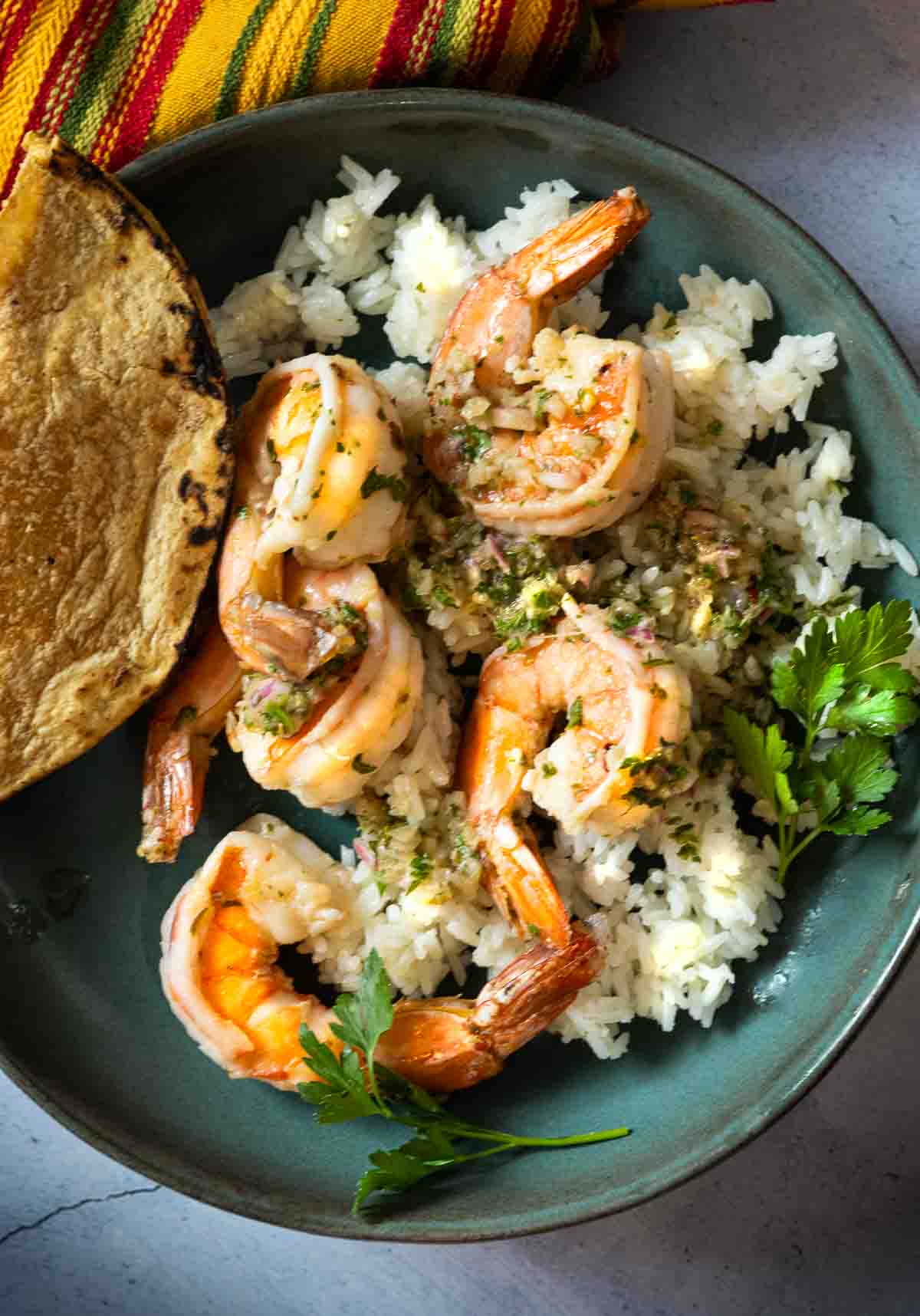 Chimichurri Shrimp served over white rice and with a corn tortilla.