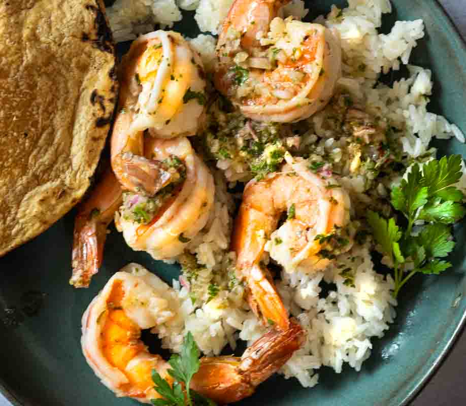 Chimichurri Shrimp served over white rice and with a corn tortilla.