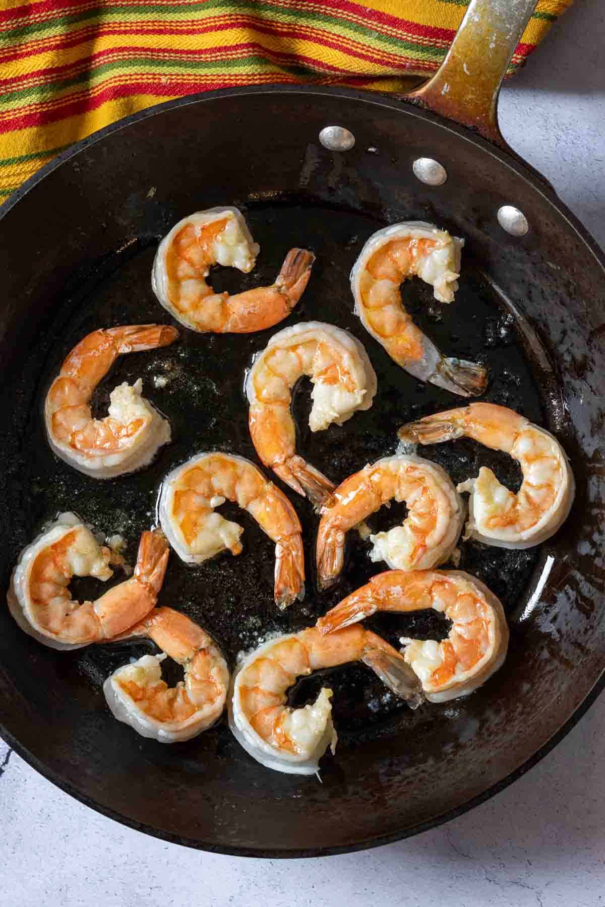 Cooking shrimp in a skillet to make shrimp chimichurri.