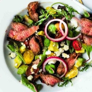 Honey glazed skirt steak salad with avocado and pickled onions.