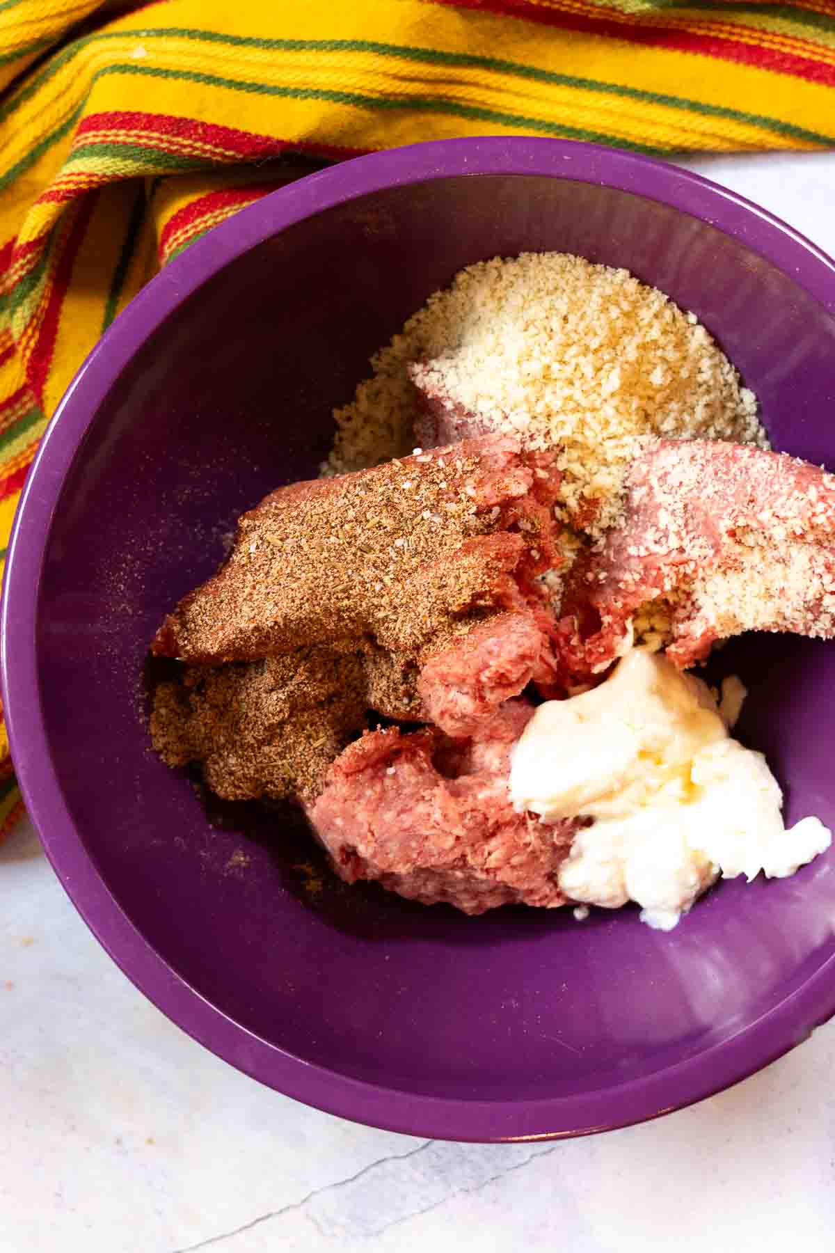 Mixing ingredients to make a taco burger.