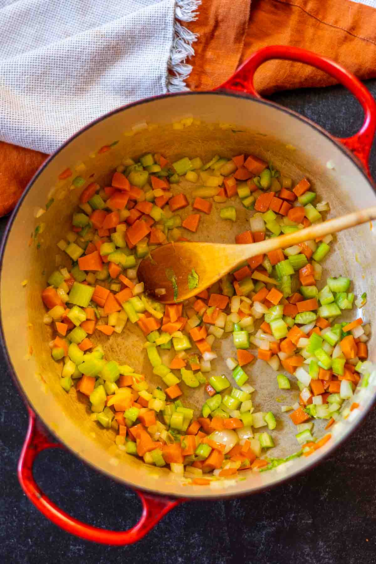 Cooking vegetables in a Dutch Oven to make Hamburger Potato Soup.