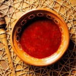 A bowl of red chile sauce made from red chile powder.