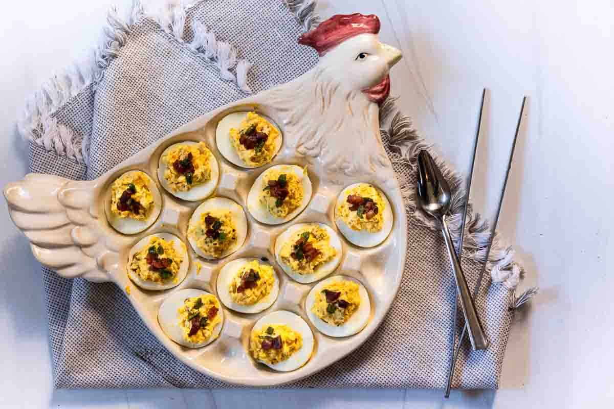 Bacon Jalapeno Deviled Eggs on a Chicken deviled egg plate.