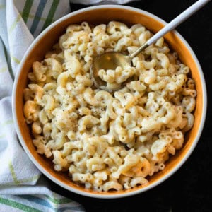 White cheddar mac and cheese in an orange bowl.