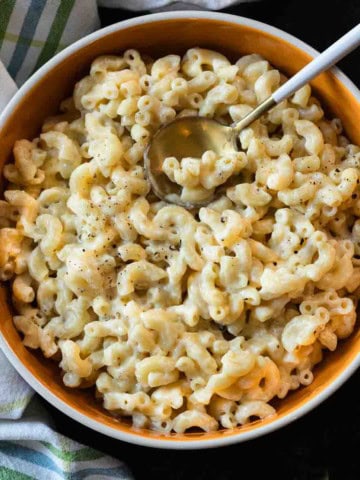 White cheddar mac and cheese in an orange bowl.