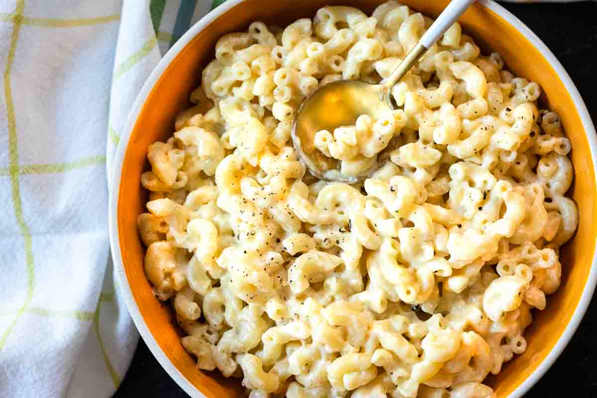 A bowl of white cheddar mac and cheese made with elbow macaroni.