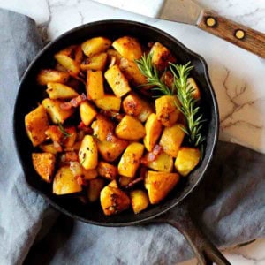 Potatoes cooked in a cast iron skillet.