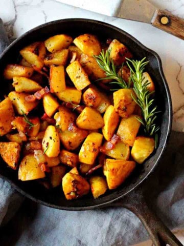 Potatoes cooked in a cast iron skillet.