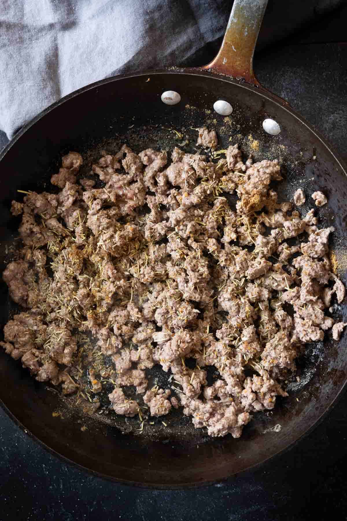Cooking and seasoning lamb to make lamb ragu.
