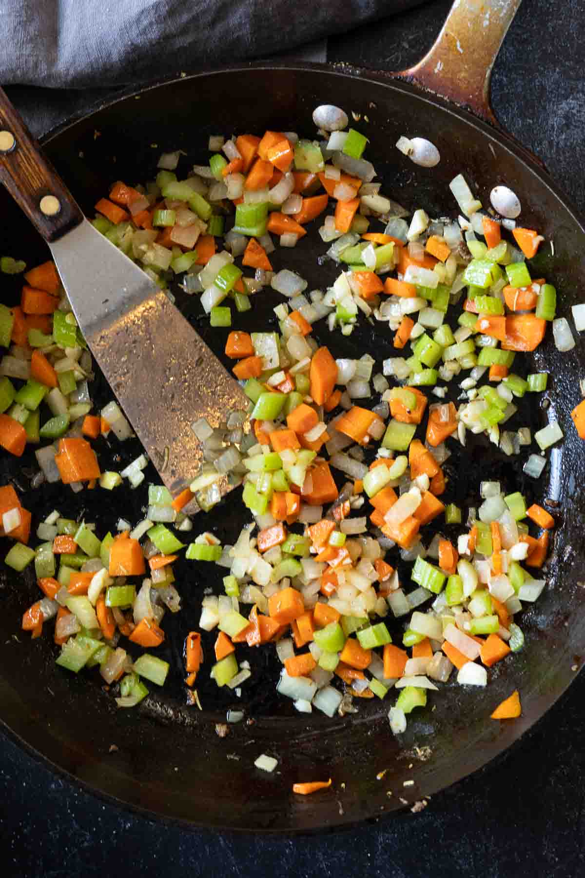 Cooking vegetables to make lamb ragu.