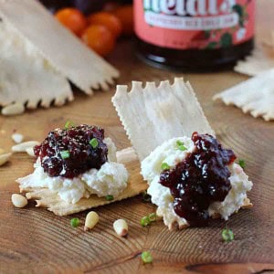 Gourmet cracker with goat cheese and raspberry jam.