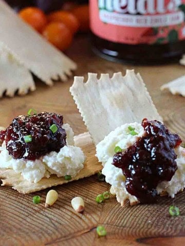 Gourmet cracker with goat cheese and raspberry jam.