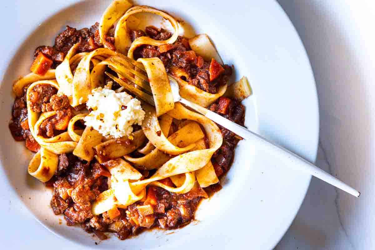 Lamb ragu with Pappardelle pasta topped with ricotta cheese.