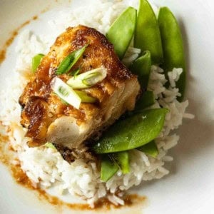 Pan seared Chilean Sea Bass served over rice and snow peas.