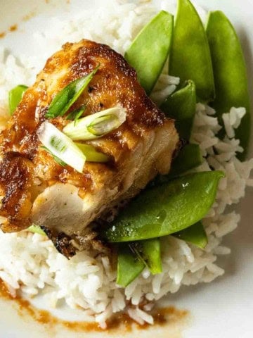 Pan seared Chilean Sea Bass served over rice and snow peas.