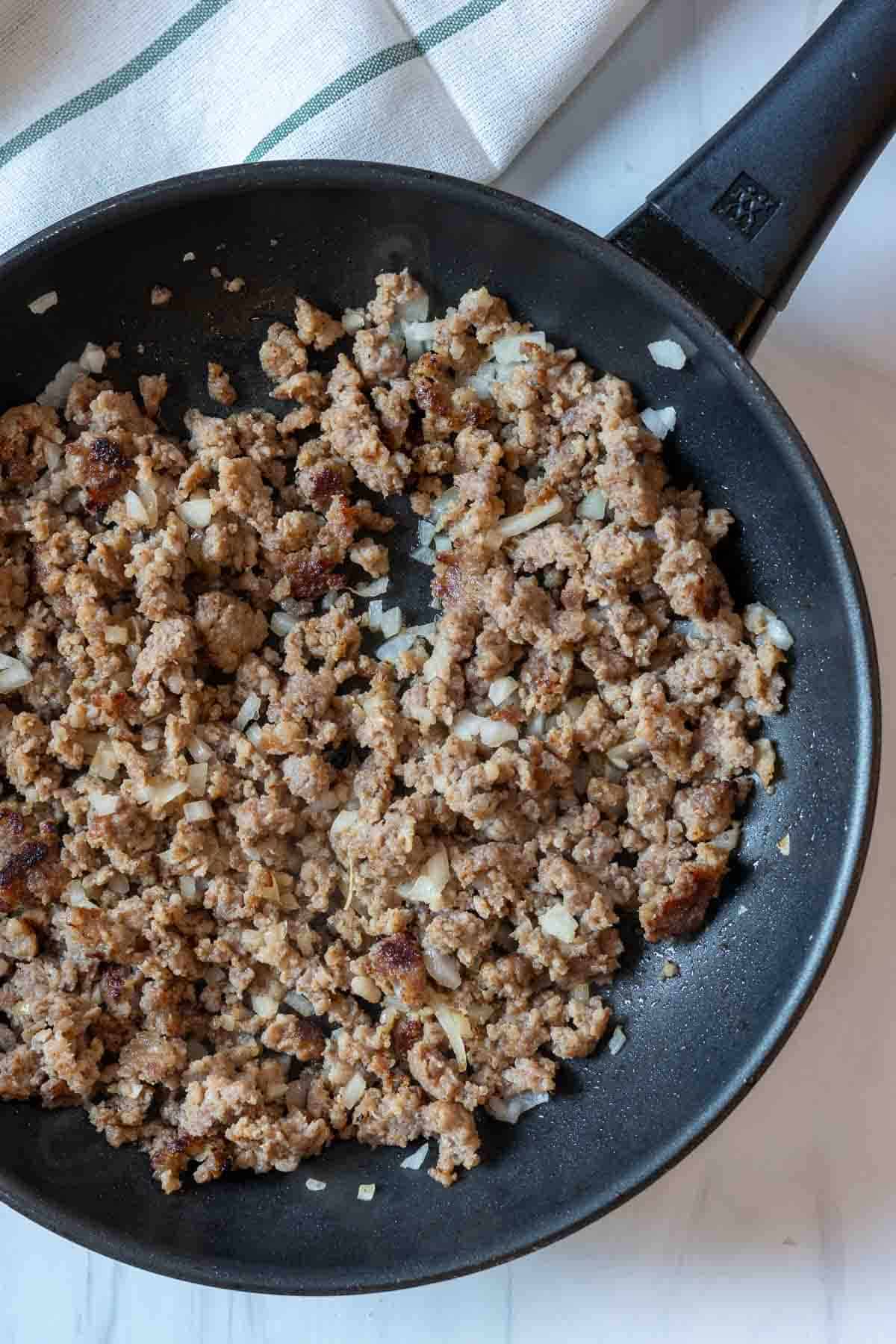 Browning breakfast sausage to make sausage pancakes.