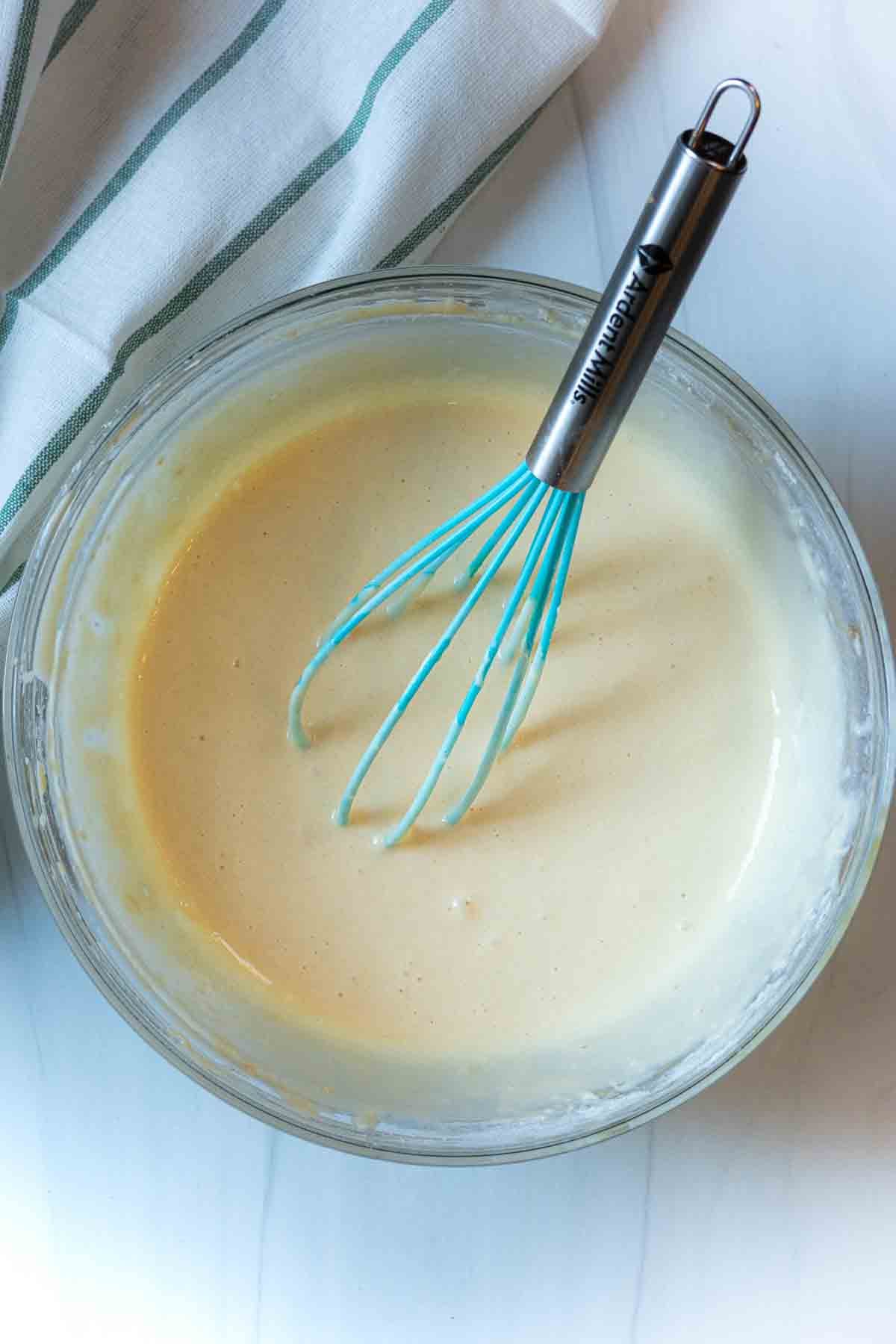 Making homemade pancake batter for sausage pancakes.