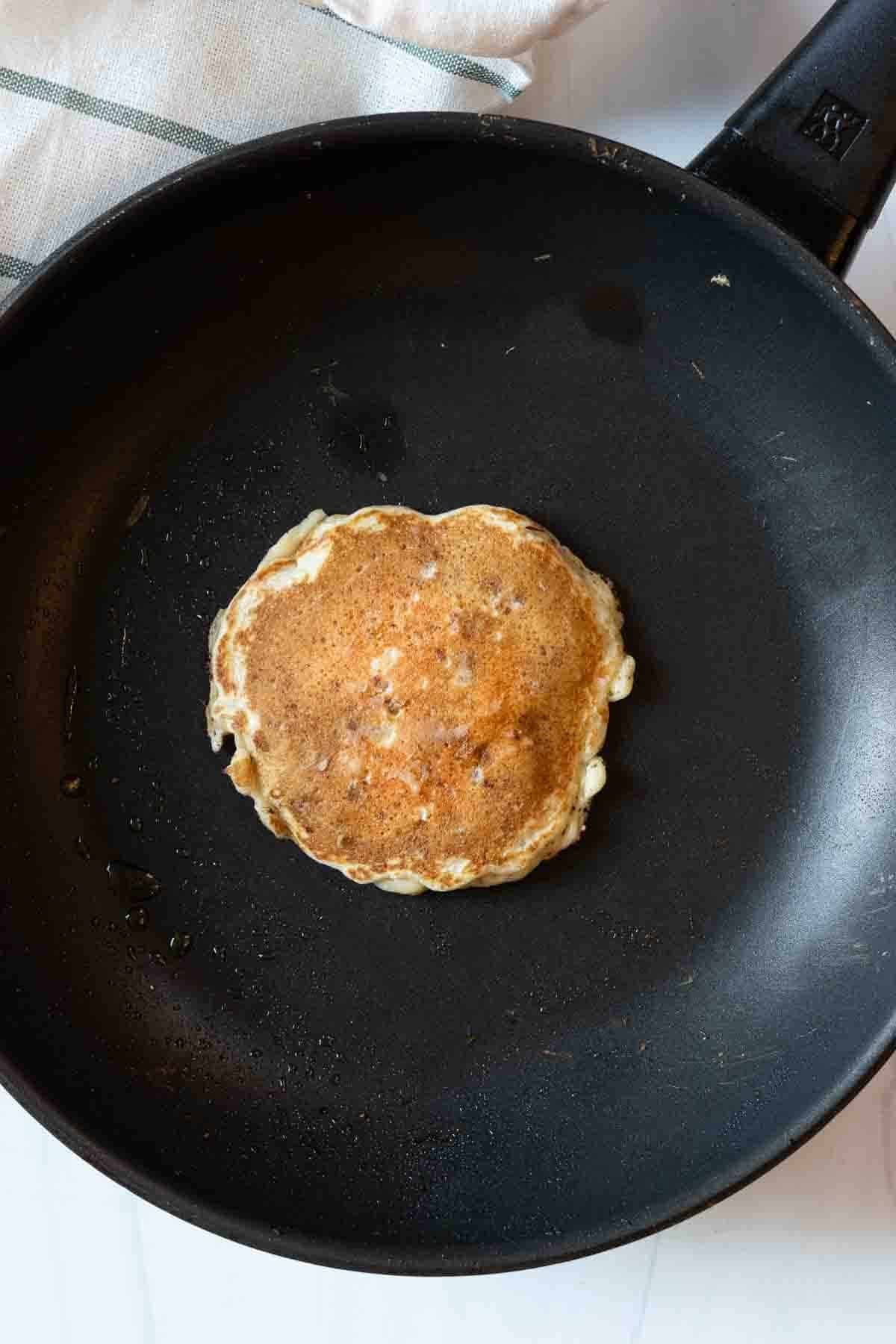 Making sausage pancakes in a skillet.