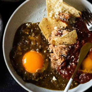 Mexican Divorced Eggs served on a plate with corn chips.