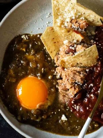 Mexican Divorced Eggs served on a plate with corn chips.