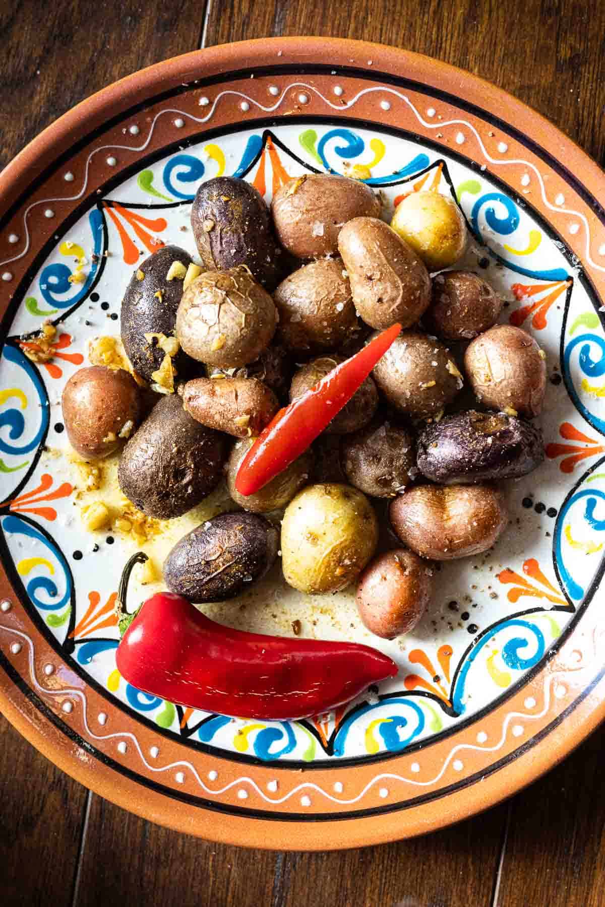 Marbled potatoes with toasted cumin and garlic garnished with a Fresno pepper.