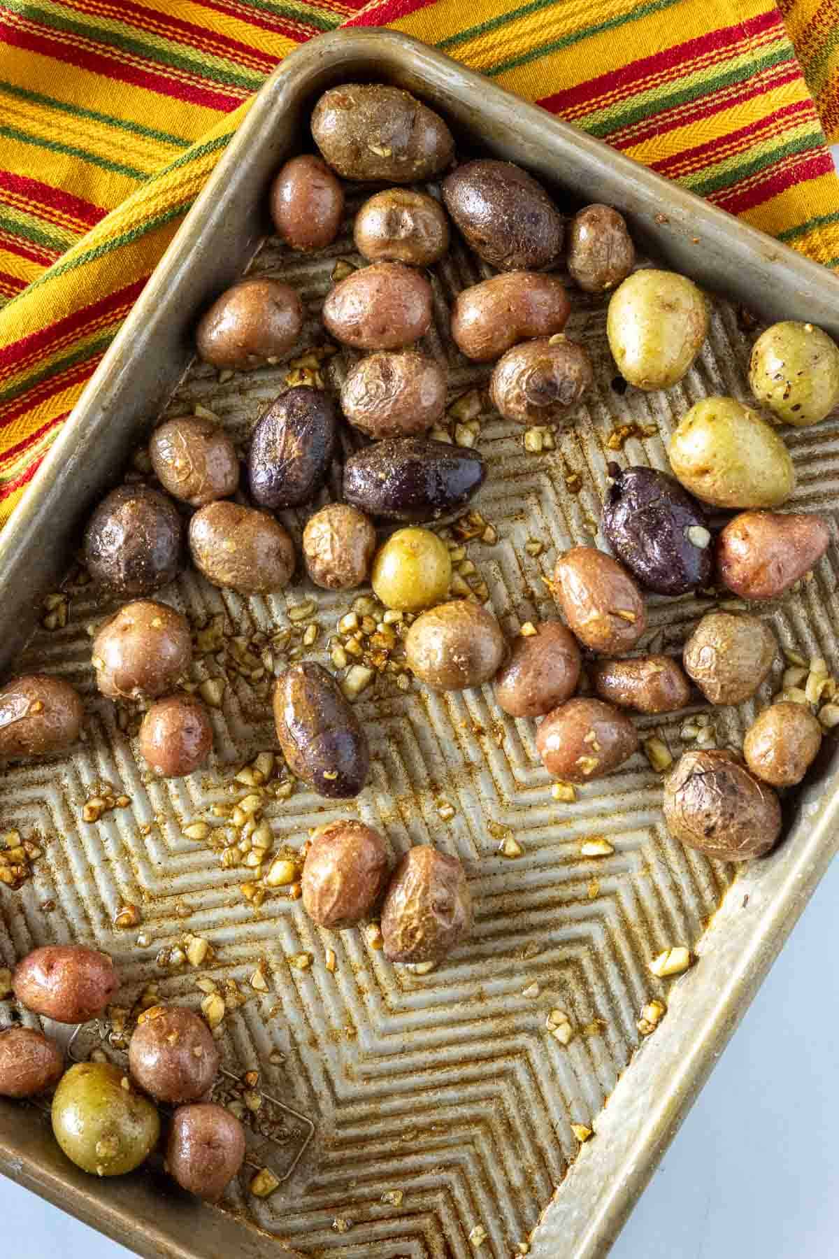 Cooking marbled potatoes on a sheet pan in the oven.