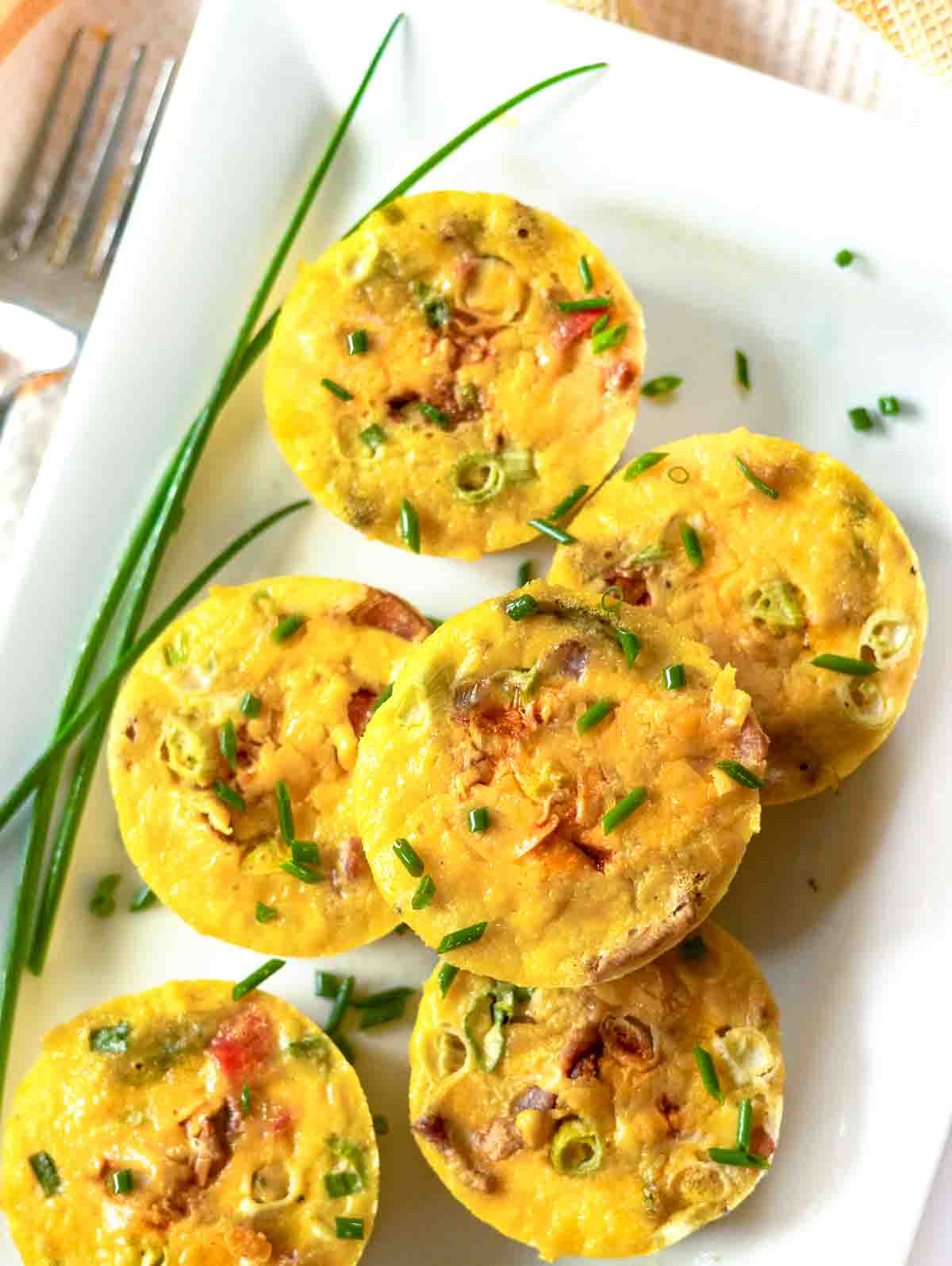 Southwestern cottage cheese egg bites with poblano peppers on a white platter.