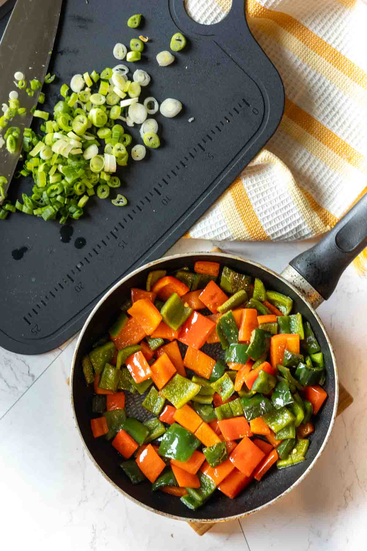 Cooked peppers in a fry pan to make cottage cheese egg bites.