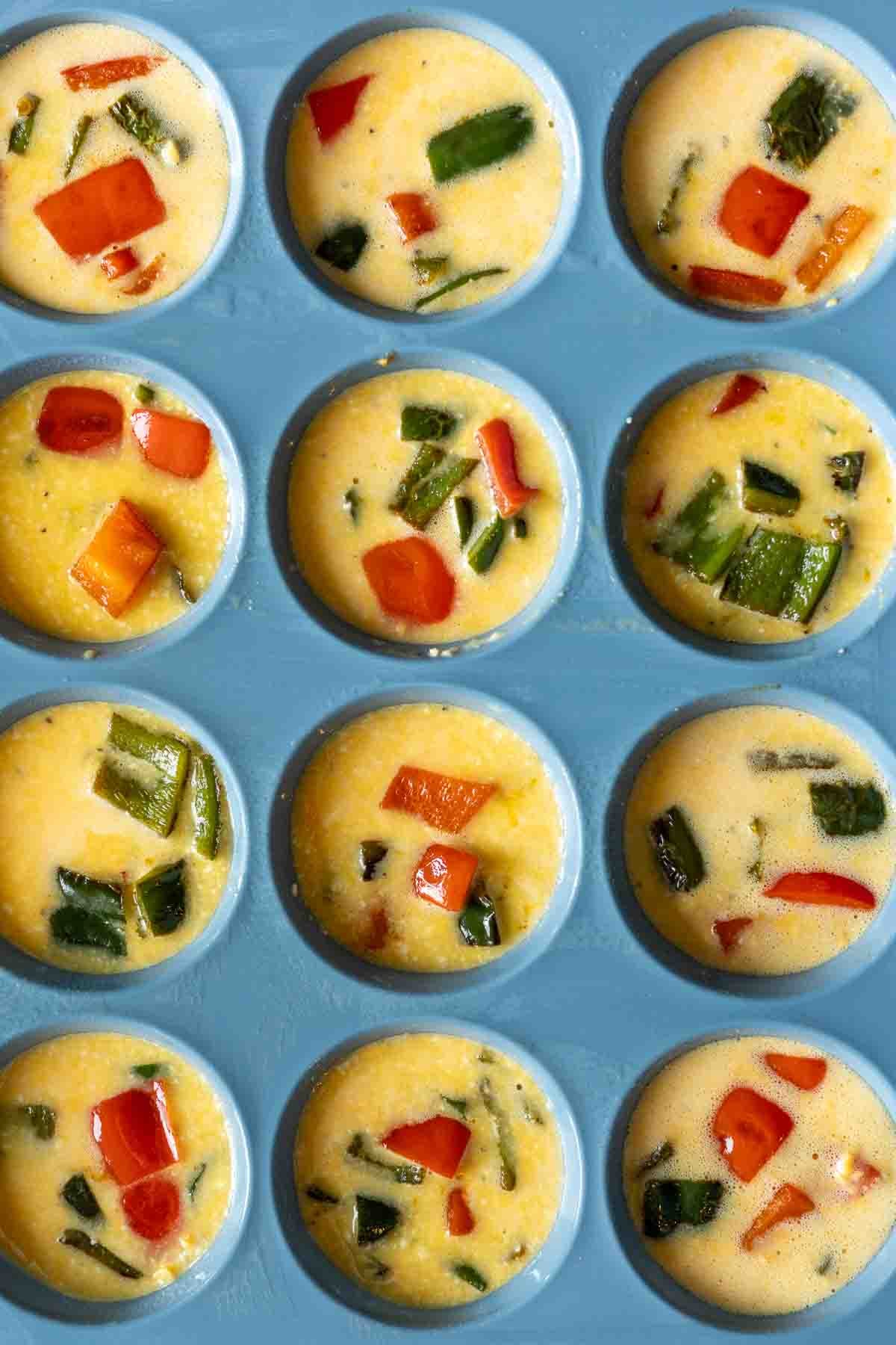 Adding peppers to cottage cheese egg bites in a muffin pan.