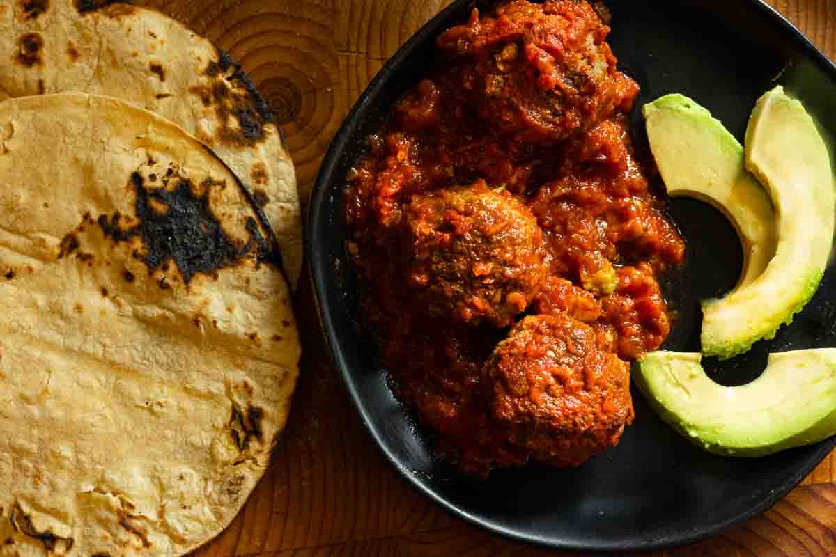 Bison meatballs served with avocado and toasted corn tortillas.