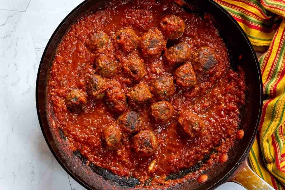 Cooking bison meatballs in chipotle salsa sauce.