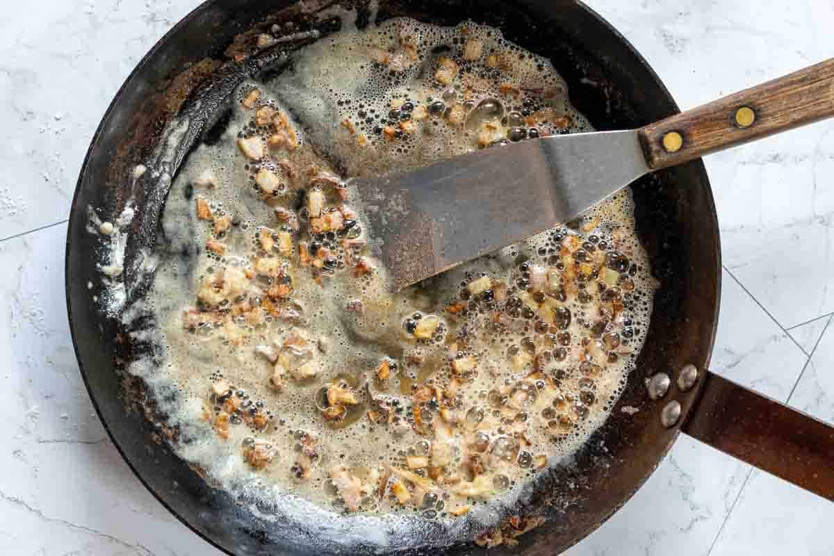 Cooking shallots to make blue cheese sauce for a Denver steak.