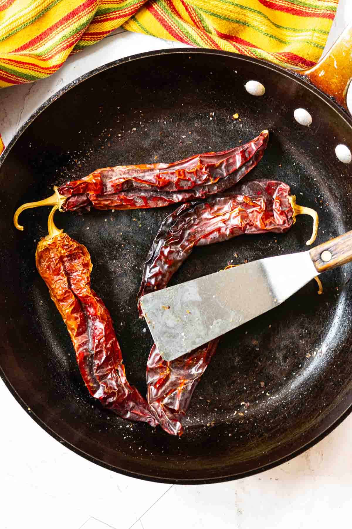Step 2 to make pork tenderloin taocs, toasting the guajillo chile peppers.