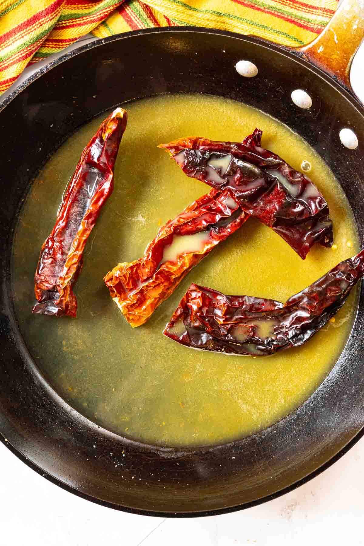 Step 3, soaking the chile peppers in orange juice to make pork tenderloin tacos.