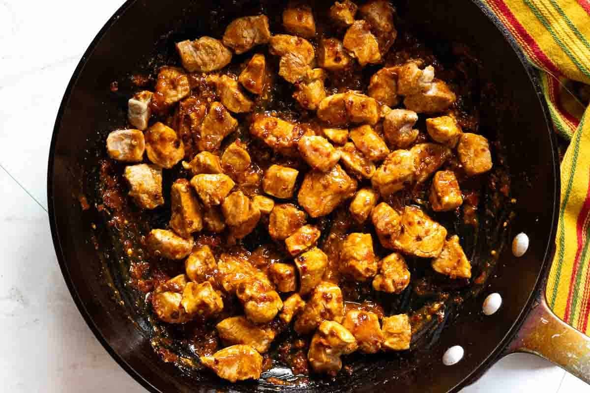 Pork tenderloin simmering in a Guajillo chile sauce.