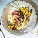 Denver steak with blue cheese sauce served with fried potatoes.