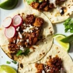 Pork tenderloin tacos with guajillo chile sauce.
