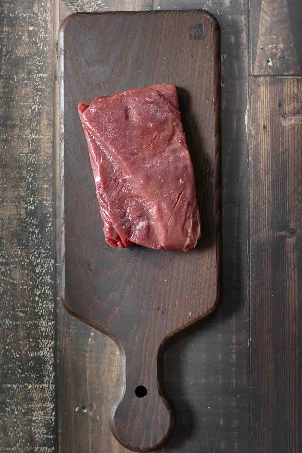 A merlot steak on a cutting board.